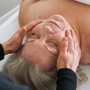 Woman receives lymph drainage therapy at Whole Being Massage