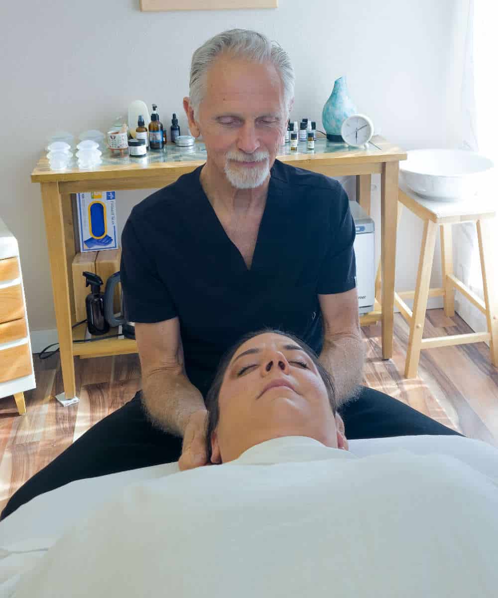 Female receives craniosacral therapy in Boise with John at Whole Being Massage