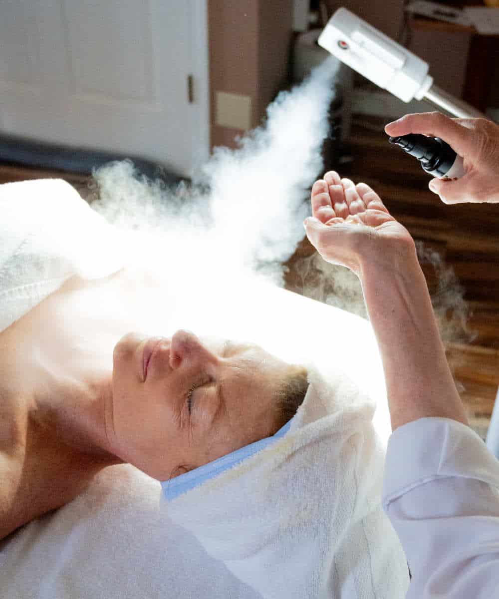 Relaxing organic facial treatment with warm steam, highlighting a rejuvenating self-care experience as part of monthly wellness membership at Whole Being Massage.
